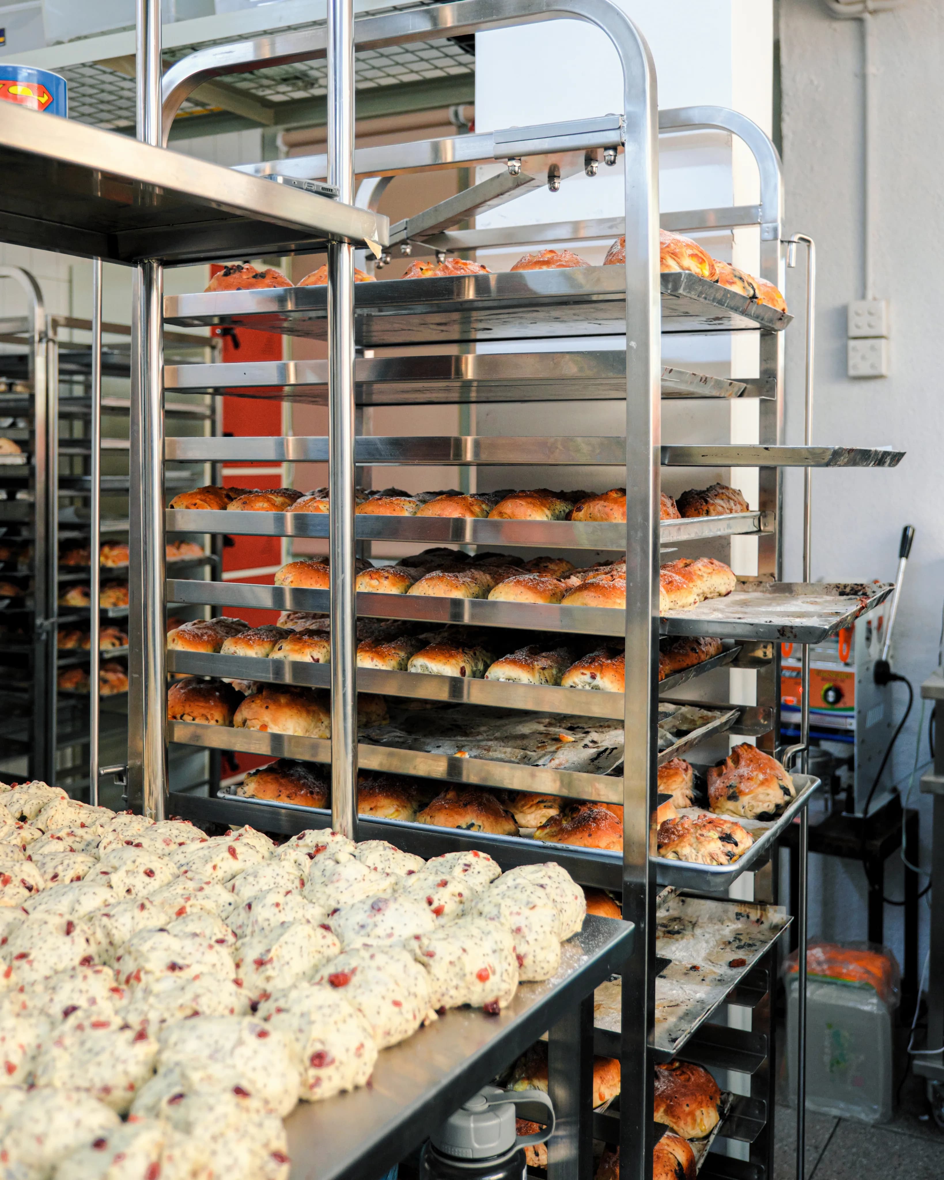 Racks of shaped loaves waiting their turn in front of the oven